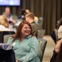 person laughing at luncheon table photo 2